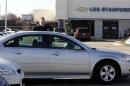 A customer looks at a 2009 Chevrolet Impala sedan at a dealership in Dearborn, Michigan