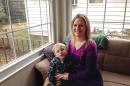 Sarah Bergstrom poses for a photo with her son Blake, 4, Friday, Jan. 17, 2014, in her home in Charleston, W.Va. The 29-year-old nurse who is 4 months pregnant with her second child was devastated when she learned after a ban on tap water was lifted days after a chemical leak that health officials urged pregnant women not to drink tap water until the chemical is entirely undetectable. (AP Photo/John Raby)