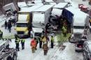 In this photo provided by the Indiana State Police, emergency crews work at the scene of a massive pileup involving more than 40 vehicles, many of them semitrailers, along Interstate 94, Thursday afternoon, Jan. 23, 2014, near Michigan City, Ind. At least three were killed and more than 20 people were injured. (AP Photo/Indiana State Police)