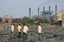 Employees work at a plant of Indian Metal and Ferro Alloys Limited (IMFA) at Choudwar in Cuttack