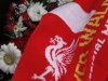A football scarf lies with floral tributes at the Hillsborough memorial outside Liverpool Football Club's Anfield stadium