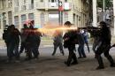 Riot police fire tear gas at demonstrators during a protest against fare hikes for city buses in Sao Paulo
