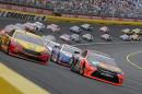 Martin Truex Jr (78) and Joey Logano (22) lead the field out of Turn 4 for the start of the NASCAR Sprint Cup series auto race at Charlotte Motor Speedway in Concord, N.C., Sunday, May 29, 2016. (AP Photo/Chuck Burton)