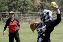 Under the watchful tutelage of US trainers on a field in Baghdad a few dozen Iraqis took a swing at softball