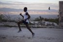 In this Jan. 7, 2013 photo, Astrel Clovis, a 42-year-old marathon runner, trains in the early morning in Petionville, a suburb of Port-au-Prince, Haiti. Like virtually all Haitians in the capital of 3 million, the runner's life was disrupted by the catastrophic earthquake on Jan. 12, 2010. But a month later he was back on the streets, resuming his routine along with the rest of the country. Six days a week, the rail-thin athlete sets off at daybreak. Clovis has run the hills and streets of Port-au-Prince for the past 10 years. He decided to take the sport seriously after he entered a race in downtown Port-au-Prince on a whim - and won. (AP Photo/Dieu Nalio Chery)