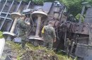 Handout photo of soldiers near the overturned wagons of a derailed train in Huamanguillo
