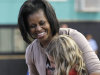 First Lady Michelle Obama laughs as she talks to two you children at the Holiday Park Gym, Wednesday, Aug. 22, 2012 in Fort Lauderdale, Fla. (AP Photo/Alan Diaz)