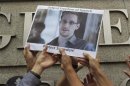File photo of protesters holding photo of Snowden during a demonstration outside the U.S. Consulate in Hong Kong