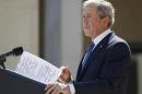 Former U.S. President George W. Bush delivers remarks with some hand-written notes during the dedication ceremony of the George W. Bush Presidential Center in Dallas