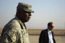 U.S. Army General Austin, commander of U.S. forces in Iraq, greets last group of soldiers to cross Kuwaiti border as part of last U.S. military convoy to leave Iraq