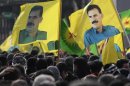 Demonstrators hold flags with portraits of jailed PKK leader Abdullah Ocalan in Strasbourg