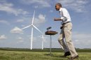 As wind turbines turn on the distance, President Barack Obama changes direction as he walks from a podium after speaking at the Heil family farm , Tuesday, Aug. 14, 2012, in Haverhill, Iowa, during a three day campaign bus tour through Iowa. (AP Photo/Carolyn Kaster)
