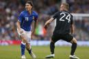 Italy's Riccardo Montolivo, left, is tackled by Republic of Ireland's Alex Pearce and is injured from the tackle during their international friendly soccer match at Craven Cottage, London, Saturday, May 31, 2014. (AP Photo/Sang Tan)