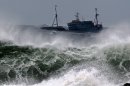 A Chinese fishing boat navigates through rough waves caused by Typhoon Bolaven in waters off Seogwipo on Jeju Island, South Korea, Monday, Aug. 27, 2012. (AP Photo/Yonhap, Kim Ho-cheon) KOREA OUT