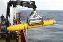 In this Monday, April 14, 2014, photo provided by the Australian Defense Force an autonomous underwater vehicle is prepared to be deployed from ADV Ocean Shield in the search of the missing Malaysia Airlines Flight 370 in the southern Indian Ocean. The search area for the missing Malaysian jet has proved too deep for the robotic submarine which was hauled back to the surface of the Indian Ocean less than half way through its first seabed hunt for wreckage and the all-important black boxes, authorities said on Tuesday. (AP Photo/Australian Defense Force, Lt. Kelli Lunt) EDITORIAL USE ONLY