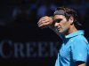 Roger Federer of Switzerland wipes his brow during his men's singles match against Benoit Paire of France at the Australian Open tennis tournament in Melbourne