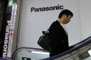 Man walks past Panasonic Corp's logos at an electronics store in Tokyo