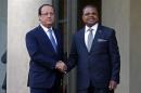 France's President Hollande greets Prime Minister of the Central African Republic Nicolas Tiangaye in the courtyard of the Elysee Palace at the start of the Elysee Summit for Peace and Security in Africa, in Paris