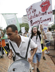 Ganzalo Valdes, of Tampa, Fla., marches with demonstrators in Tampa, Fla., Sunday, Aug. 26, 2012. Hundreds of protestors gathered in Gas Light Park in downtown Tampa to march in demonstration against the Republican National Convention. (AP Photo/Dave Martin)