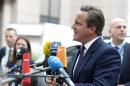 Britain's Prime minister David Cameron talks to journalists as he arrives to attend an European Union emergency summit on the migration crisis at the EU Headquarters in Brussels, September 23, 2015