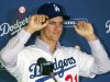 New Los Angeles Dodgers pitcher Zack Greinke adjusts his cap during a baseball news conference announcing his $147 million, six-year contract, Tuesday, Dec. 11, 2012, in Los Angeles. (AP Photo/Damian Dovarganes)
