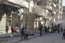 Residents inspect damage after an airstrike on the rebel held al-Fardous neighbourhood of Aleppo