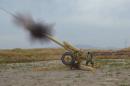 Afghan National Army soldiers fire artillery during a battle with Taliban insurgents in Kunduz