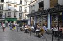 People sit outside on July 12, 2013 in the Rue des Rosiers, the Jewish area of the Marais district in Paris