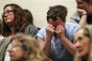 Local residents attend a community prayer service at the Haller Middle School in Arlington