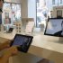 A customer looks at the screen of an iPad in an Apple store in central Prague