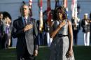 U.S. President Barack Obama and first lady Michelle Obama observe a moment of silence on the South Lawn of the White House to mark the 14th anniversary of the 9/11 attacks, in Washington