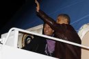 US President Obama waves next to first lady Michelle Obama at Joint Base Andrews outside Washington