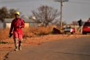 A mine worker walks home after his shift at the Driefontein Mine in Carletonville, near Johannesburg, September 4, 2013