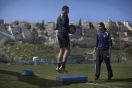 Beitar Jerusalem F.C. soccer player Zaur Sadayev, left, train in Jerusalem, Friday, Feb. 8, 2013. The offices of the Beitar Jerusalem soccer team were set on fire early Friday in an apparent arson attack, police said, a day after four of the club's fans were charged with anti-Muslim chanting at a recent game. Tensions have been bubbling ever since the team announced last month it would sign on two Muslim Chechen players — Zaur Sadayev and Gabriel Kadiev — in a break from the team's unofficial tradition of not signing Arabs or Muslims. (AP Photo/Bernat Armangue)