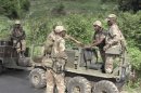 Armed South African soldiers talk in Begoua