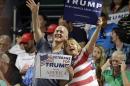 Supporters of Republican presidential candidate Donald Trump wave before a rally in Greensboro, N.C., Tuesday, June 14, 2016. (AP Photo/Chuck Burton)