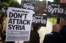 Demonstrators protest against potential military involvement in Syria outside Parliament in London on August 29, 2013