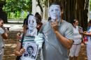 Cuban dissidents wear masks depicting US President Barack Obama as they protest against the reopening of the US embassy in the island in a park of Havana, August 9, 2015