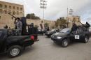 Members of the Libyan Police are seen on their vehicles as the Police prepare for deployment during the start of a security plan put forth by the Tripoli-based government to increase security in the Libyan capital, at Martyrs' Square in Tripoli