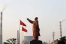 A statue of former Chinese leader Mao Zedong is seen in front of smoking chimneys at Wuhan Iron And Steel Corp in Wuhan