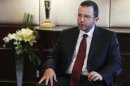Egypt's Prime Minister Hisham Kandil talks during an interview with Reuters in Cairo