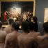 RETRANSMISSION  OF XRZ102 In this Monday, Feb. 18, 2013 photo, Naked Museum visitors look at pictures of the show "Nude Men from 1800 to Today" during a special opening to friends of nudism at the Leopold Museum, Vienna, Austria. The show "Nude Men from 1800 to Today" opened its doors from 19 October 2012 to  March  4,2013, looking at how artists have dealt with the theme of male nudity over the centuries. (AP Photo/Ronald Zak)