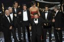 Director/producer Ben Affleck, center, accepts the award for best picture for "Argo," as the cast and crew look on during the Oscars at the Dolby Theatre on Sunday Feb. 24, 2013, in Los Angeles. (Photo by Chris Pizzello/Invision/AP)