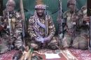 This screengrab taken on September 25, 2013 from a video distributed through an intermediary shows a man claiming to be the leader of Nigerian Islamist extremist group Boko Haram Abubakar Shekau, flanked by armed men