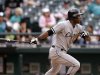 Chicago White Sox's Alejandro De Aza drives in a run against the Seattle Mariners in the 16th inning of a baseball game on Wednesday, June 5, 2013, in Seattle. (AP Photo/Elaine Thompson)