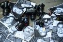 Photos of killed journalists and cameras lie outside the Veracruz state representation office during a journalists protest in Mexico City on February 11, 2016