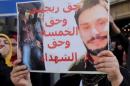 An Egyptian activist holds a poster during a demonstration in front of the Press Syndicate in Cairo