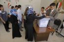 People cast their votes in the Bab al-Amr neighbourhood of Homs on June 3, 2014 in Syria's presidential election