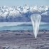 In this June 10, 2013 photo released by Jon Shenk, a Google balloon sails through the air with the Southern Alps mountains in the background, in Tekapo, New Zealand. Google is testing the balloons which sail in the stratosphere and beam the Internet to Earth. (AP Photo/Jon Shenk) EDITORIAL USE ONLY