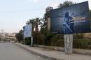 Islamic State billboards are seen along a street in Raqqa